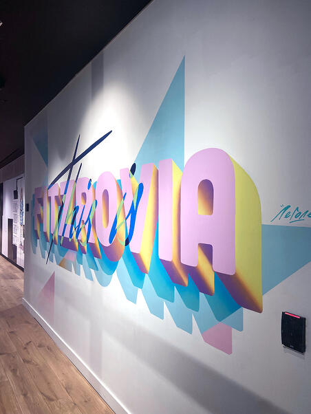A colourful mural featuring the location 'FITZROVIA' in bold pink lettering.